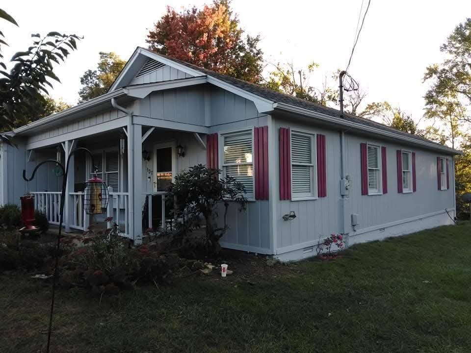 House exterior with blue-gray siding and burgundy shutters