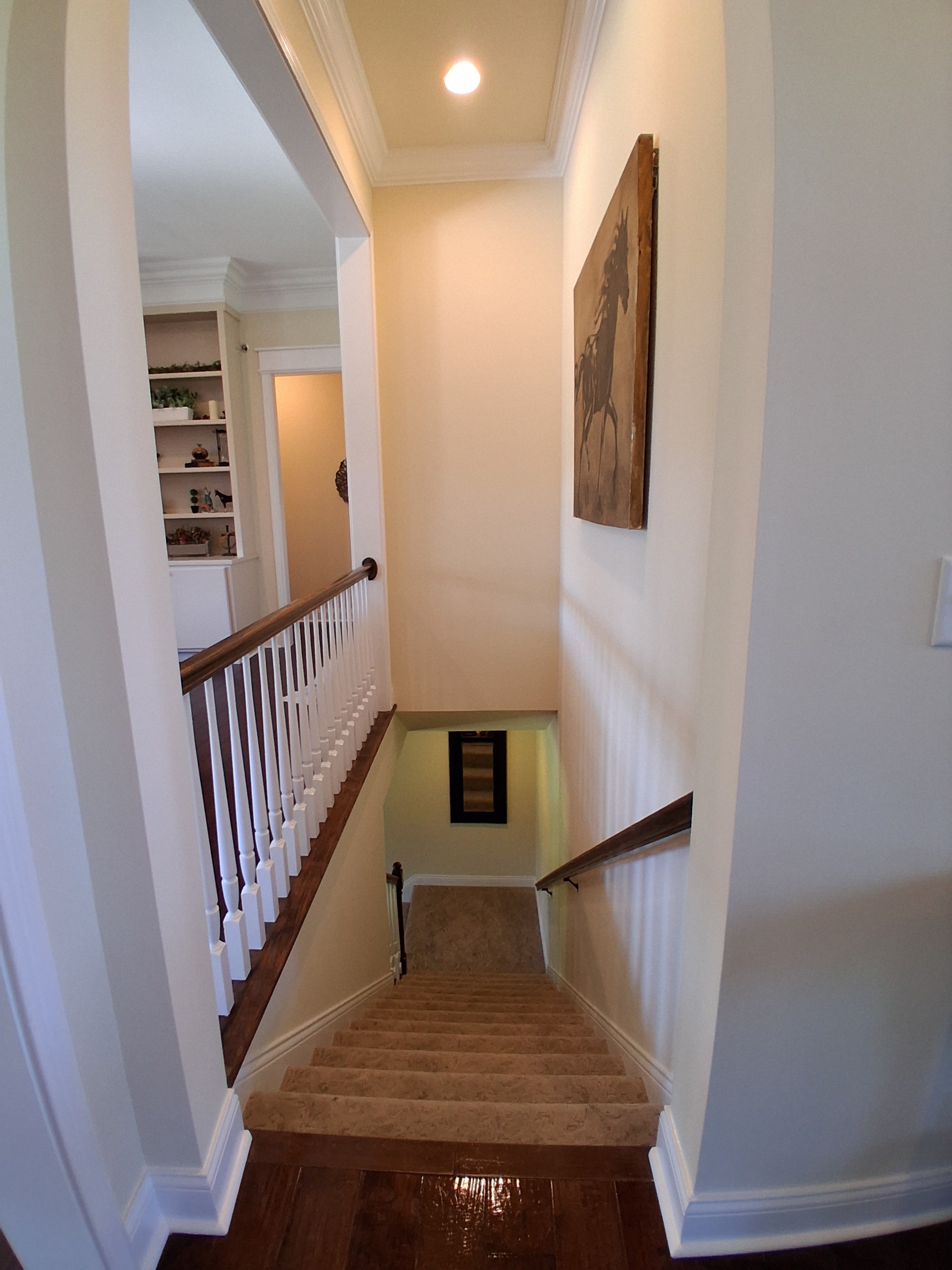 Staircase overhead view with painted walls and white balusters